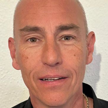 Close-up of a middle-aged man with short hair.