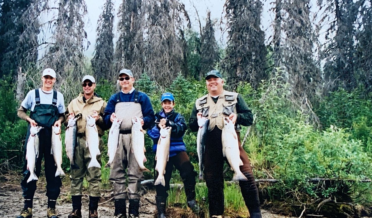 Group of fishermen holding salmon caught at Tal River