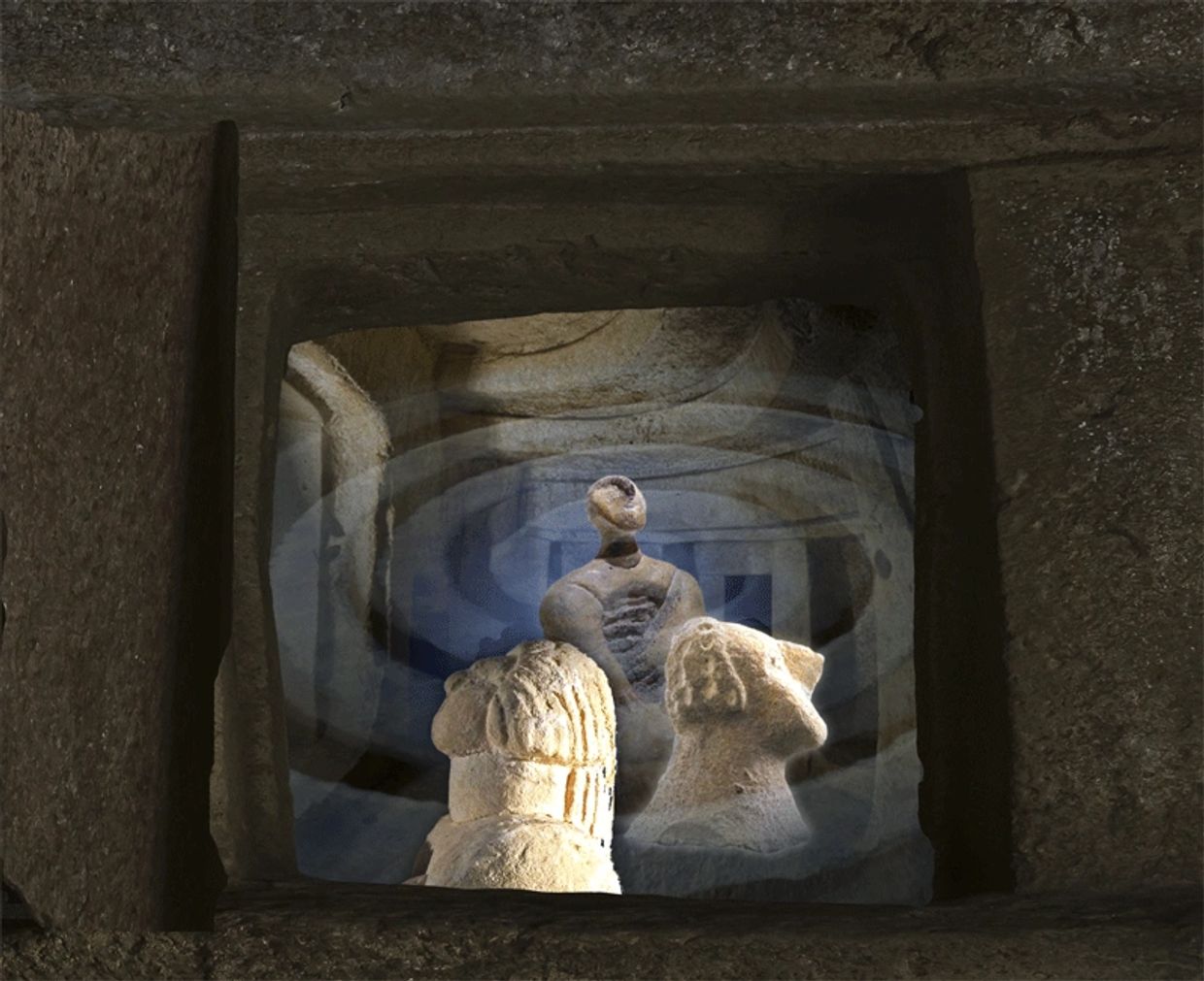 Ancient stone sculptures within a rock-cut tomb.