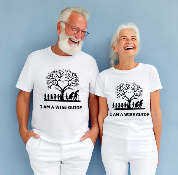 Elderly couple smiling, wearing matching 'I AM A WISE GUIDE' t-shirts.