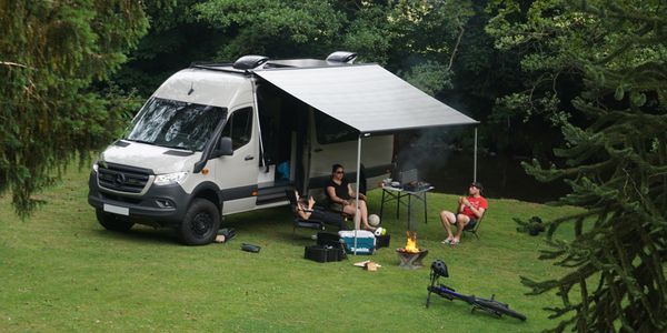 4x4 Mercedes Sprinter van family camping by river 