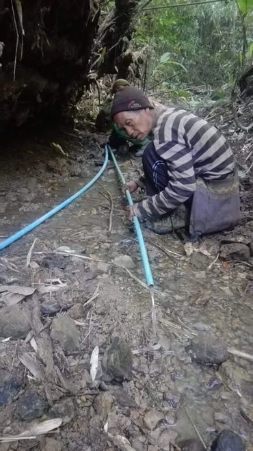 an old person checking the water pipes 