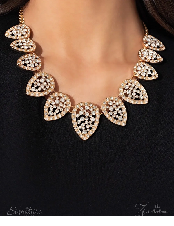 Elegant gold necklace with teardrop-shaped crystal clusters on a black background.