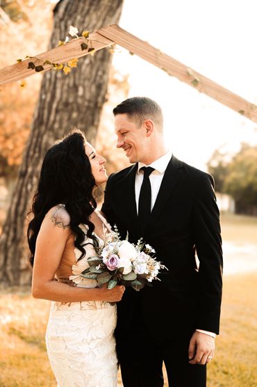 bride and groom pose at the alter