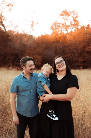 Happy family posing outdoors in autumn.
