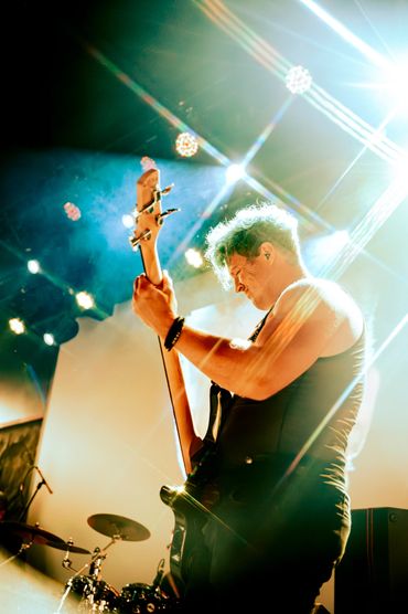 guitarist performing live onstage at a Tacoma Washington concert.
