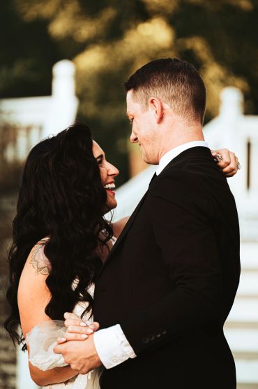 Couple smiling and holding hands.