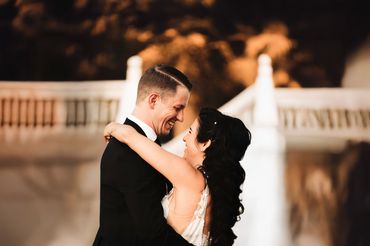 A joyful couple embraces, smiling at each other in wedding attire during western Washington wedding.