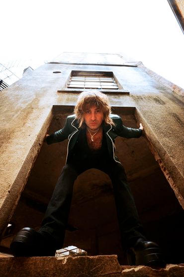 Cody Jasper photographed in the frame of an abandoned building in Tacoma, Washington