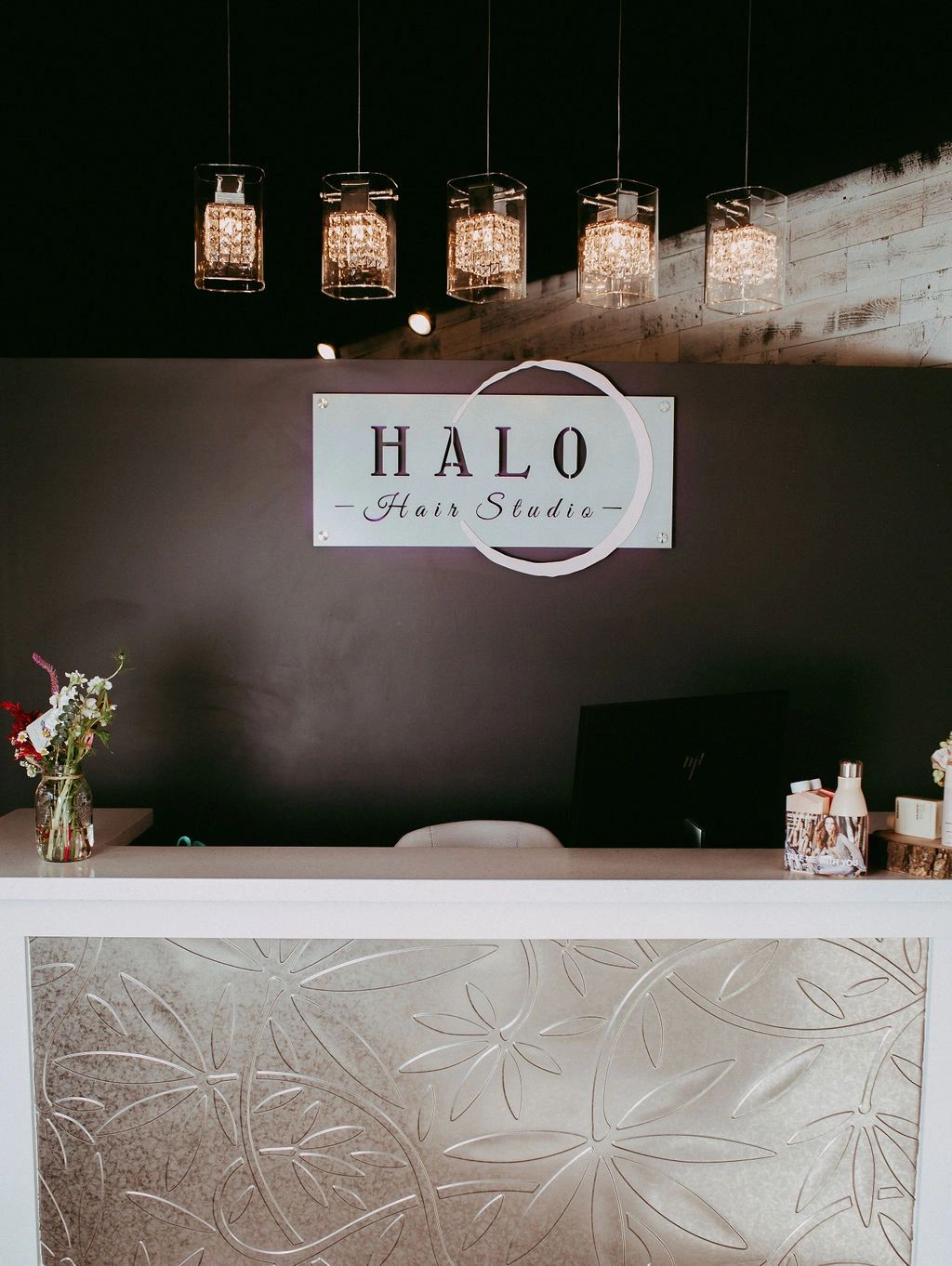 Illuminated store frontage reads "Halo Hair Studio"