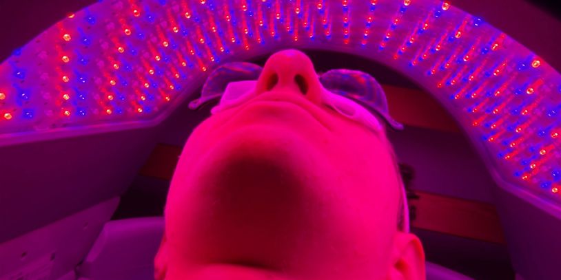 Person undergoing LED light therapy with protective goggles on.