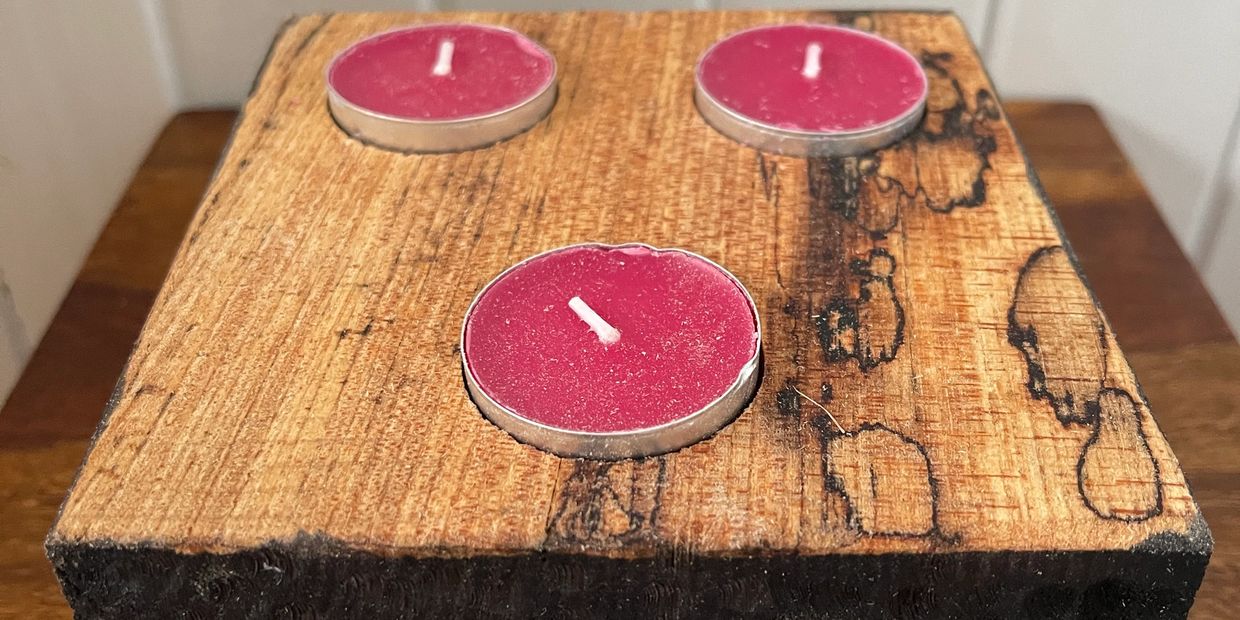 Candle holder carved from Spalted Elm Wood.  The sides are dyed back with a dimpled effect.
