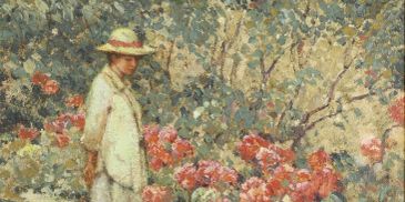 A woman stands in a garden of blooming flowers.