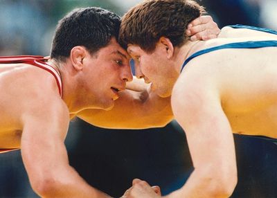 Two wrestlers locked in a close, intense match.