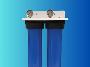 Dual blue water filter system with pressure gauges on top against blue gradient background.