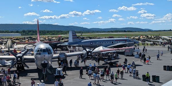 People observing airplanes by the museum.