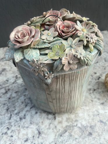 This was a labor of love.  Hand formed jar with individually created flowers and leaves.  