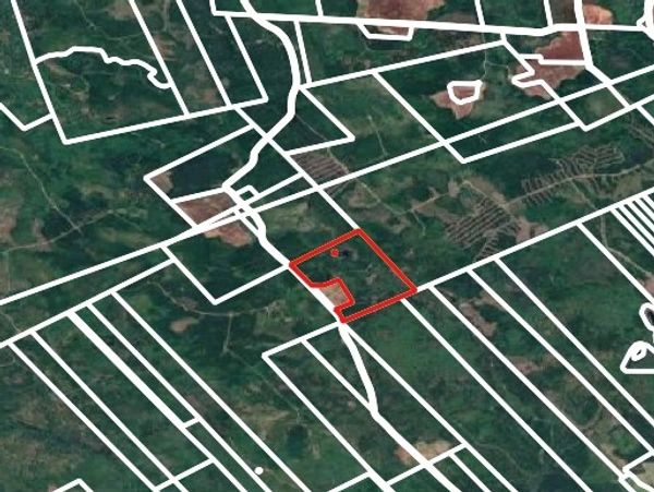 Aerial view of land parcels with one highlighted in red.