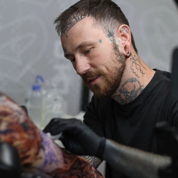 Tattoo artist focused on creating intricate body art.