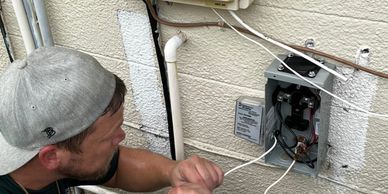 Dynamic Electric electrician troubleshooting an air condition disconnect