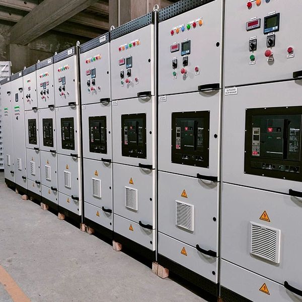 Row of industrial electrical control panels in a facility.