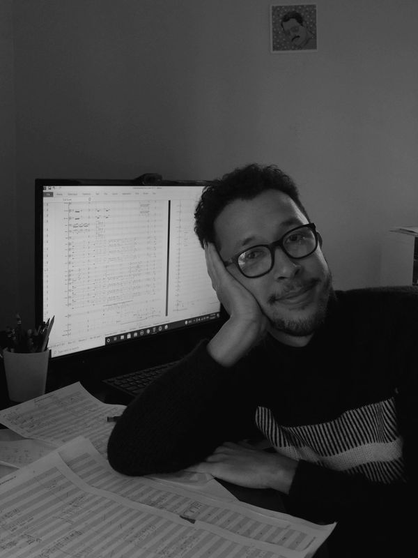 Giuseppe Gallo-Balma sitting at his desk while composing/ writing music