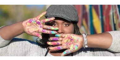 Person showing colorful paint on hands.