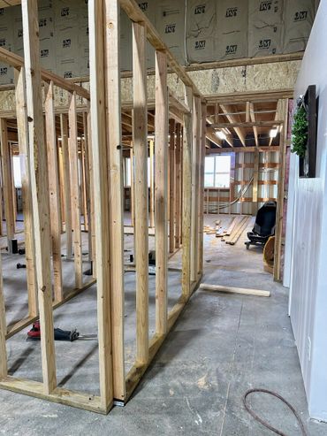 Wooden framing in progress inside a building under construction.