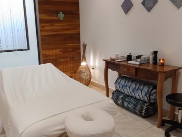A cozy massage or therapy room with a treatment table and soft lighting. 