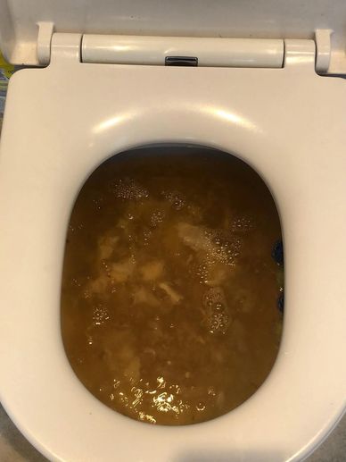 a bunch of blocked toilets with poo coming out the top and overflowing