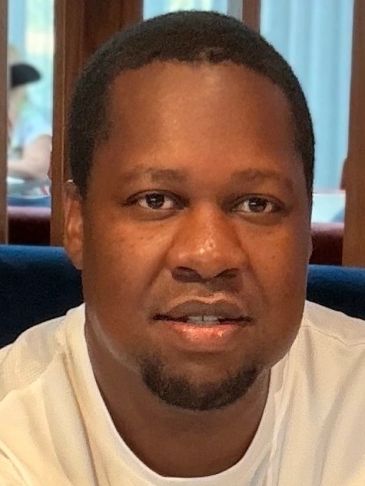Portrait of a man in a white shirt.