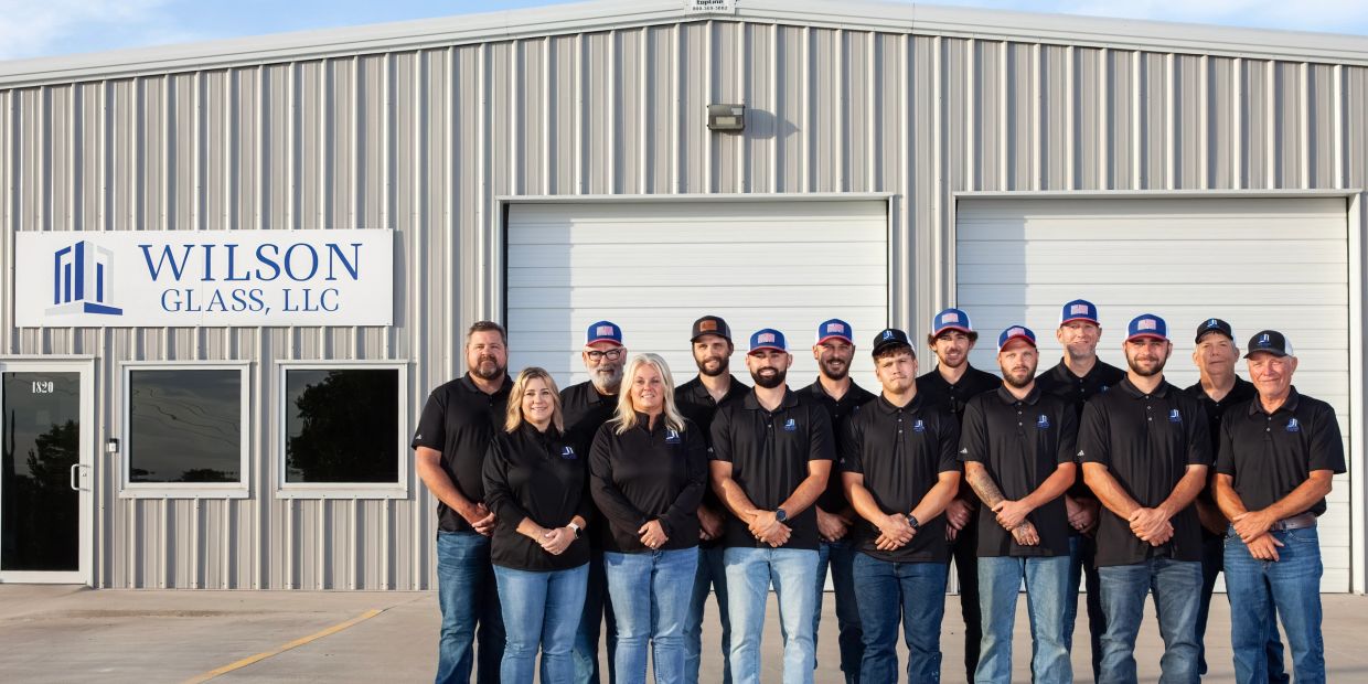 Group photo of Wilson Glass, LLC employees in front of their building.