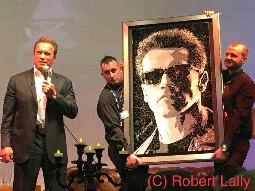 Arnold Schwarzenegger with his Robert Lally mosaic artwork.