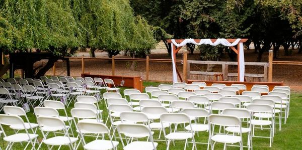 Birthday party setup with tables, chairs, bounce house, and trailer rental from Hoop Dreamz

