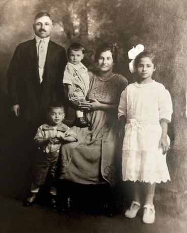 Vintage family portrait with father, mother, and three children.