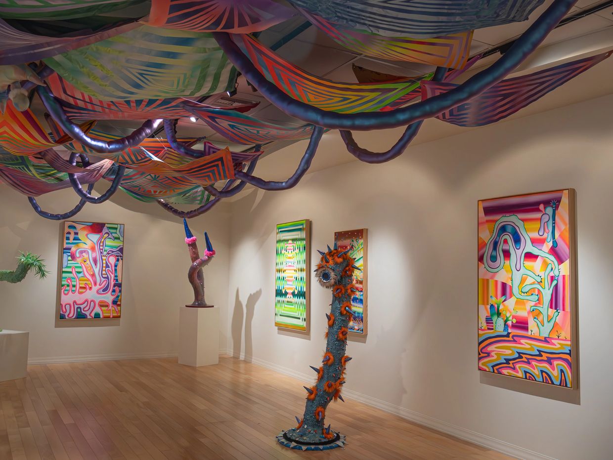 Colorful abstract art installation with ceiling decorations and sculptures.