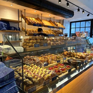 A bakery display filled with various pastries and breads.