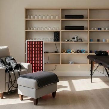 Modern therapy room with a comfortable chair and shelves of supplies.