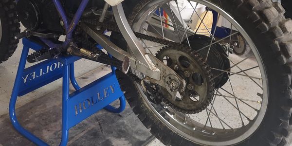 A motorcycle on top of a blue stool