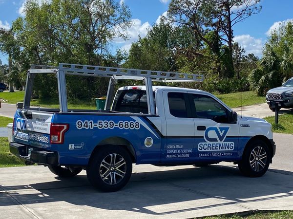 Blue and white CV Screening truck parked outdoors.
