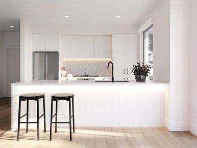 Bright, modern kitchen with white cabinetry and two black stools at the island.