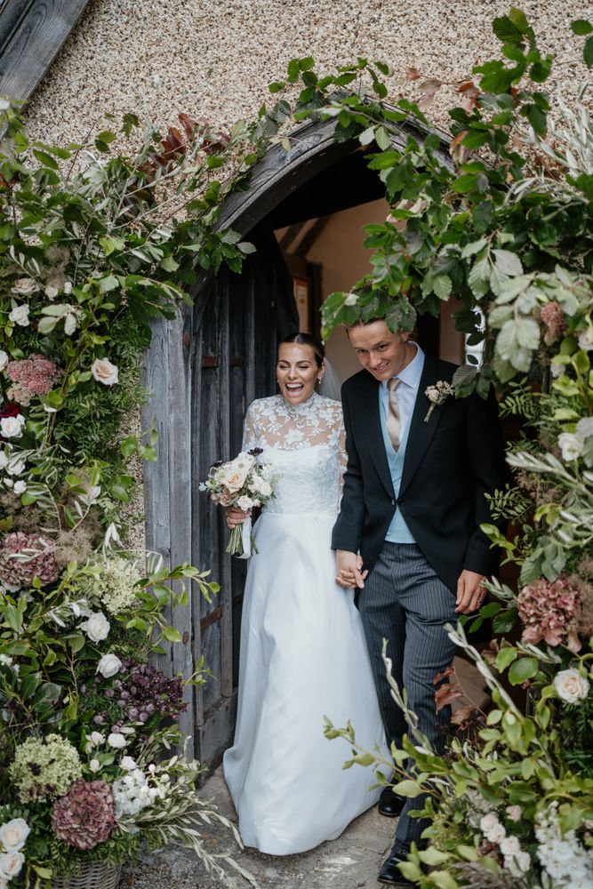 Bride and groom wedding day. Wedding floral arch. Flower arch. Wedding flowers