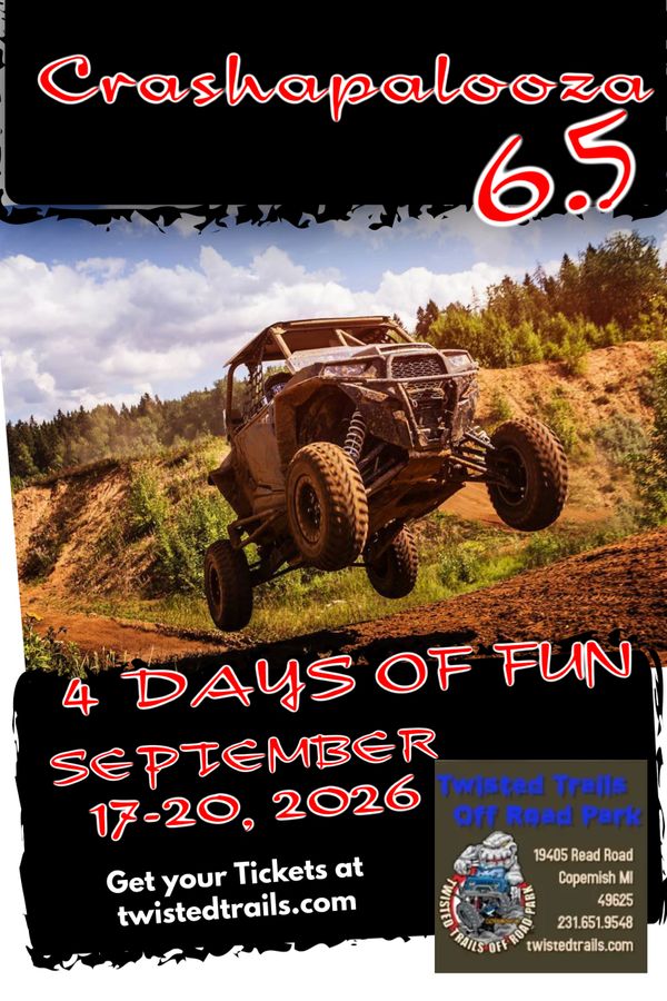 Off-road vehicle jumping mid-air at Crashapalooza 6.5 event.