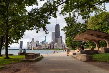 Park view with city skyline and tall buildings.