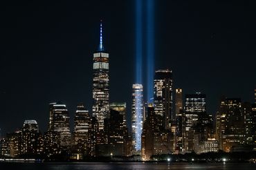 Night cityscape with twin beams of light.
