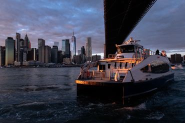 Ferry under Brooklyn Bridge