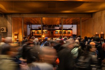 Crowded indoor area with blurred people moving.
