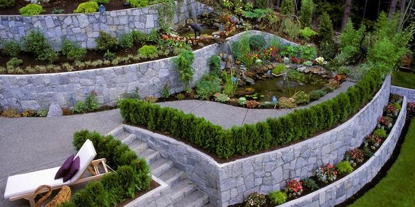 Retaining Walls with Hardscape and stair surrounded by bushes.