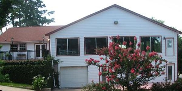 A property with white walls and red roof