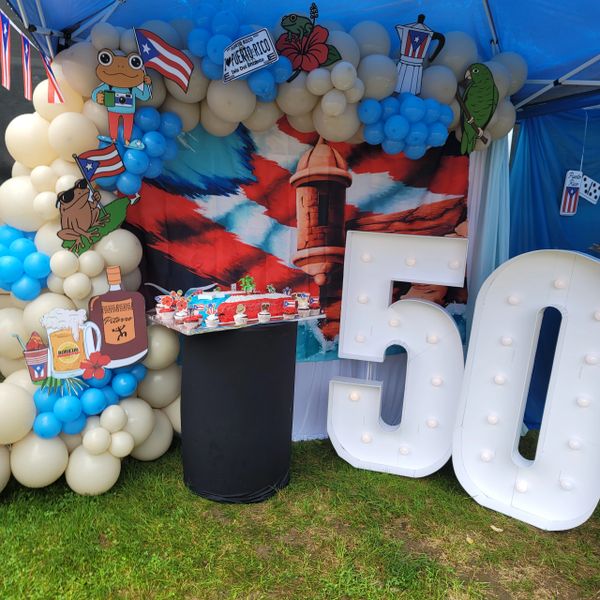 Puerto Rican-themed 50th birthday party setup with balloons and decorations.